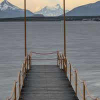 Moment from The Torres del Paine towers above a turquoise lake at sunset, Patagonia