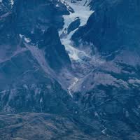 Moment from The Torres del Paine towers above a turquoise lake at sunset, Patagonia